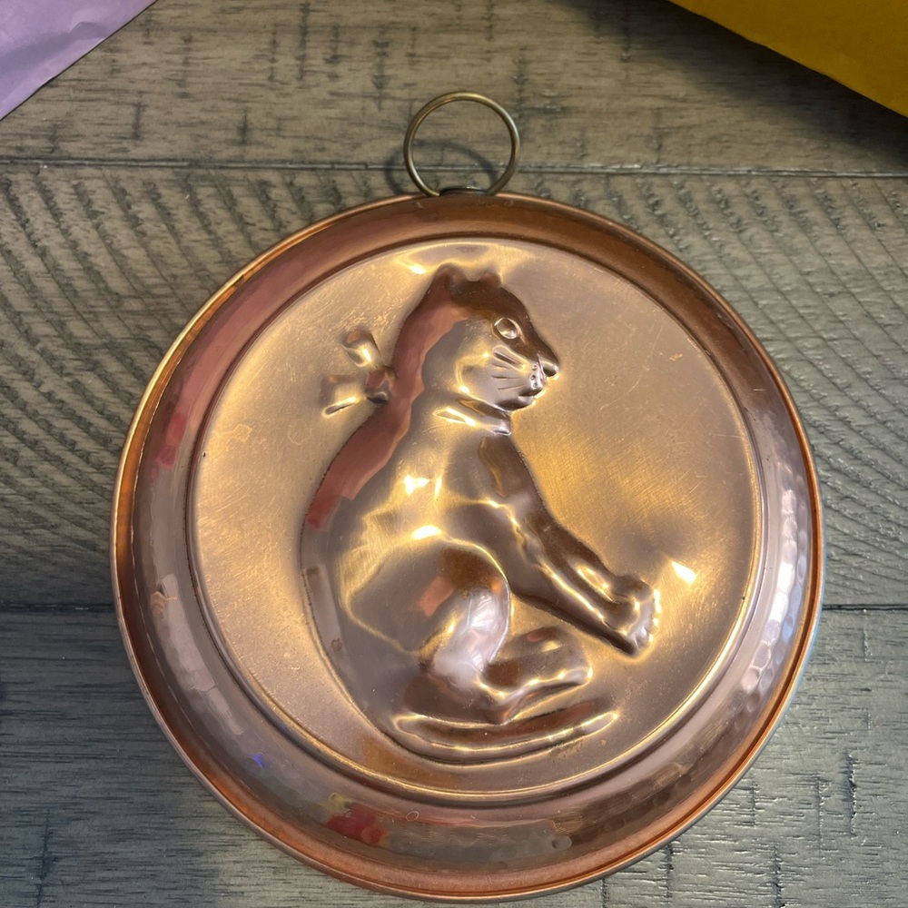 a vintage copper mold featuring a cat motif